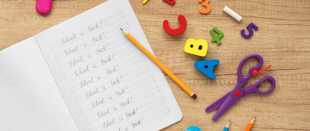 a notebook with a pencil and pencils on it