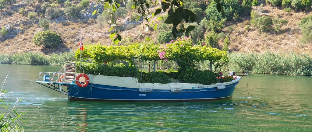 a boat covered with flowers in Dalyan River, one of the best places to visit in Dalyan