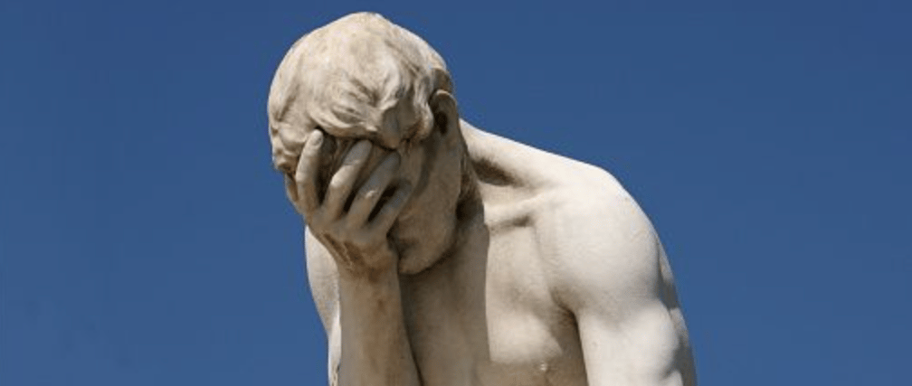 Classical statue of a Roman-era man doing a face palm