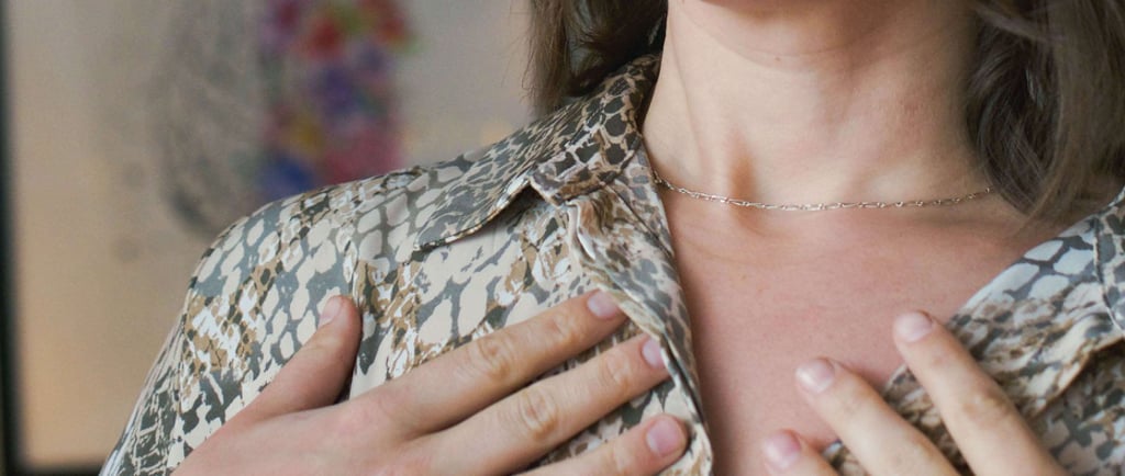 woman with short hair and eyes closed showing embodiment practices