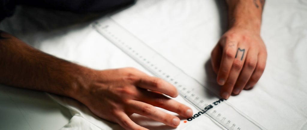 a man is looking down at a white sheet of paper