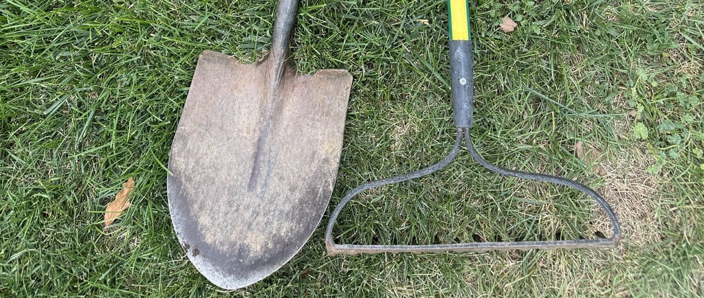 Well-used shovel and rake.