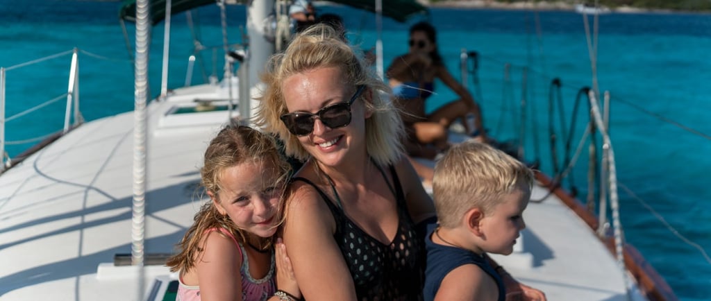 a woman and two children on a boat in cancun 