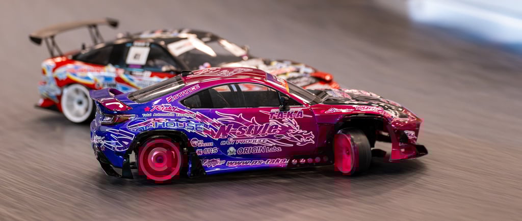 a pink and blue RC car drifting