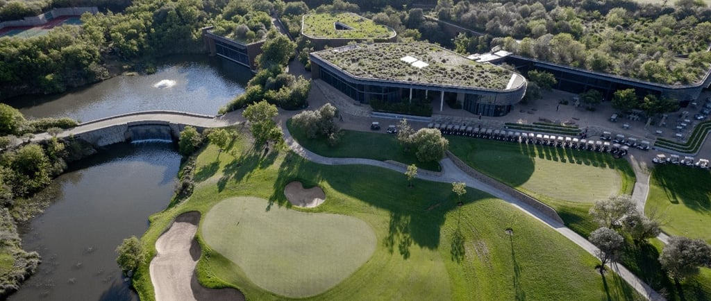 An aerial view of the 9th green and clubhouse at The Club at Steyn City, host venue of LIV Golf Sout