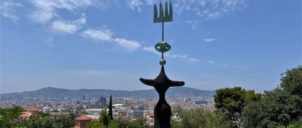 a sculpture of a woman in a black dress with Barcelona view on the background