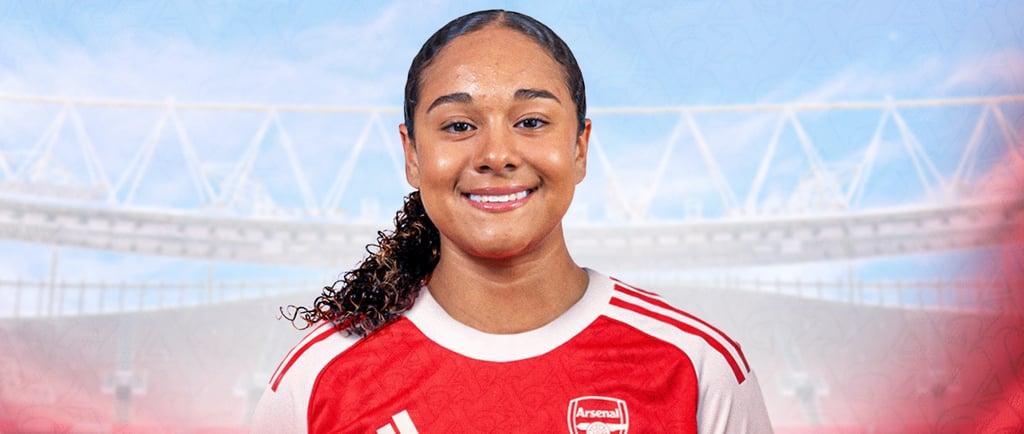 a woman in a red jersey is posing for a photo