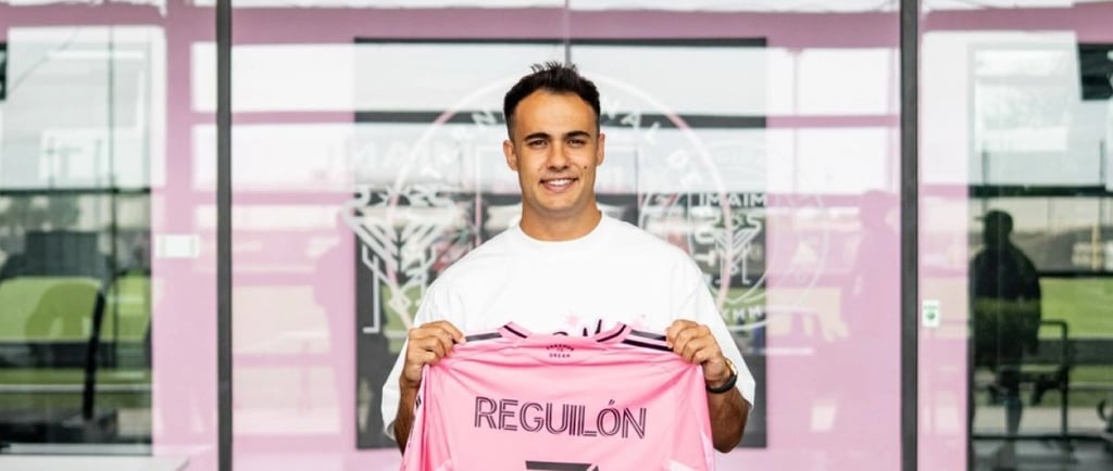 a man holding a pink soccer jersey that says resolution resolution
