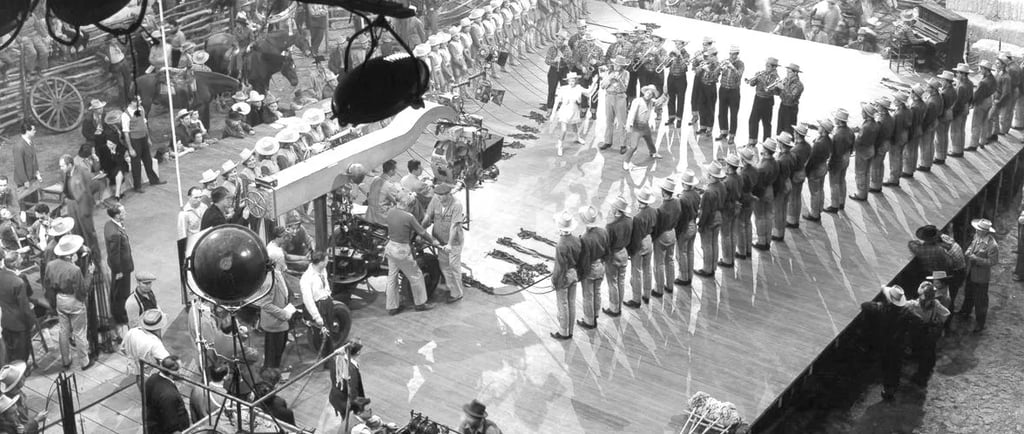 Mickey Rooney and Judy Garland dance “I Got Rhythm” as Berkeley’s camera captures a V‑shaped cowboy 