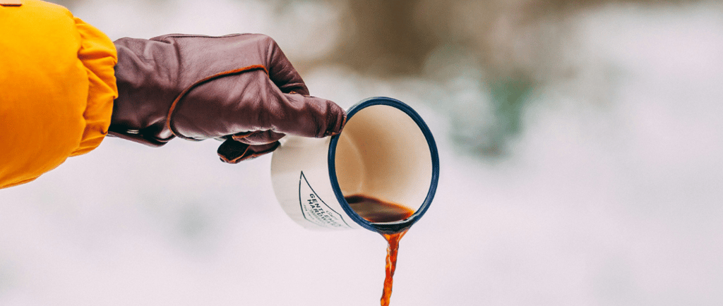 pouring a cup of coffee in the snow