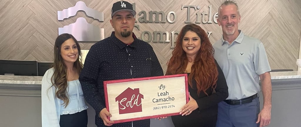 a man and woman standing in front of a sign that says,'welcome to