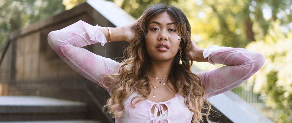 Pretty model in pink top posing in front of stairs
