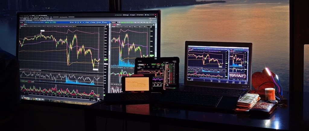 a desk with a laptop and a monitor screen