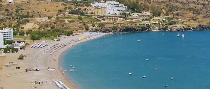a beach with a view of a beach and a boat