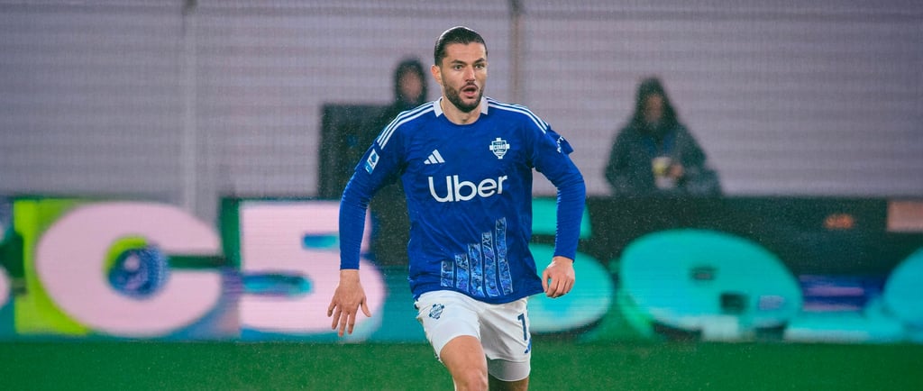 a soccer player is playing soccer on a field