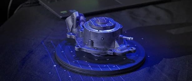 car part being 3d scanned with a blue laser