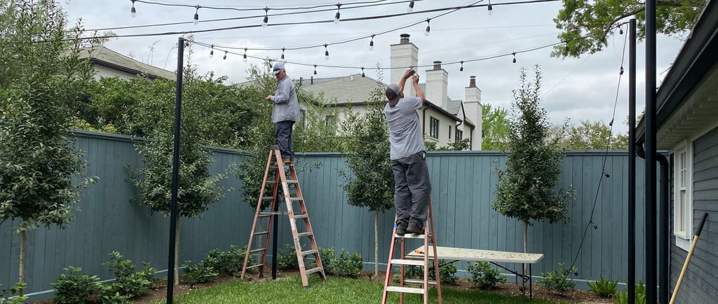 lighting technicians installing patio string lights