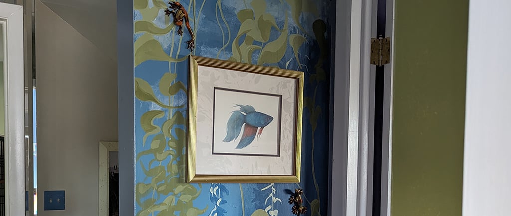 Accent wall mural of 8 by 3 feet in size of a sea kelp forest. Painted in colors to accent a favored hanging watercolor.