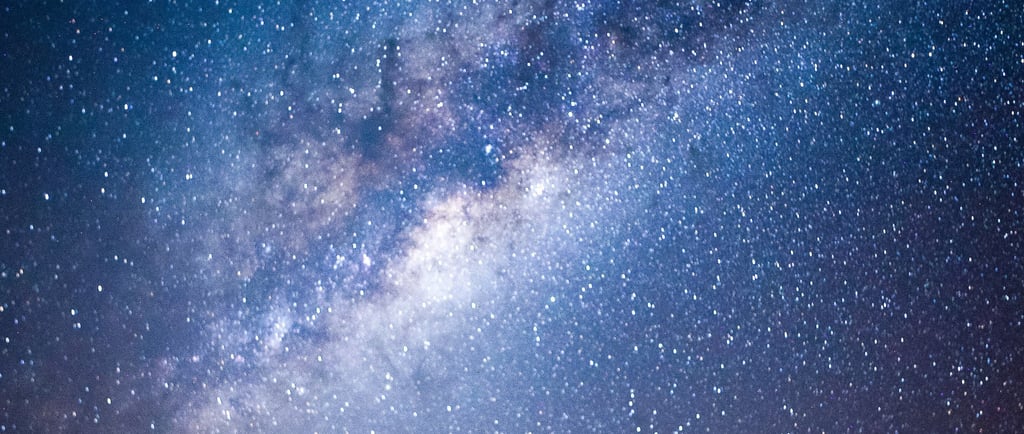 a person standing in front of a night sky