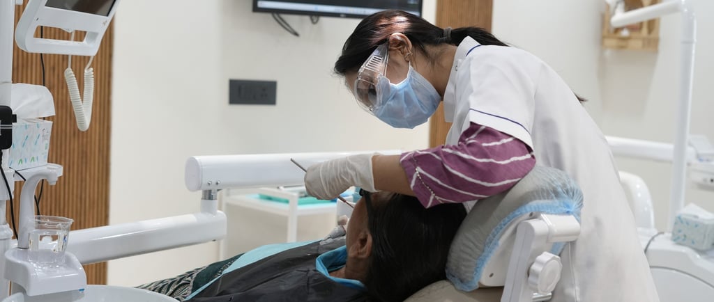 Dentist performing oral health checkup in a modern dental clinic in Gandhinagar