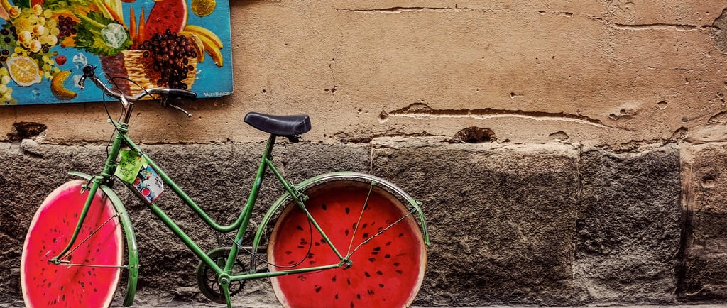 a green bicycle with a watermelon painted wheels