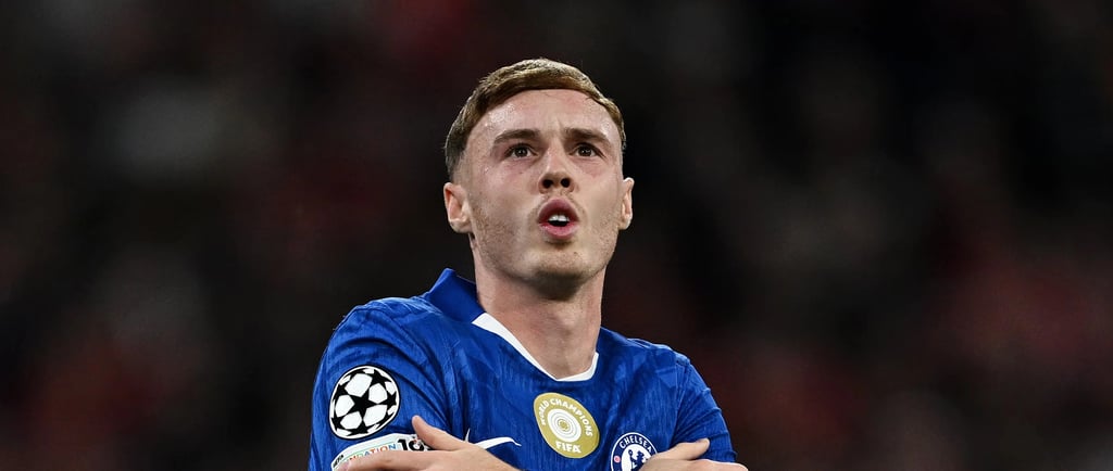 a man in a blue shirt is standing in front of a crowd