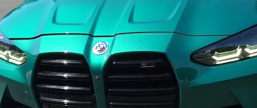 Close-up of a BMW M3's mirror-like finish after a Full Gloss Paint Protection Film (PPF) installatio