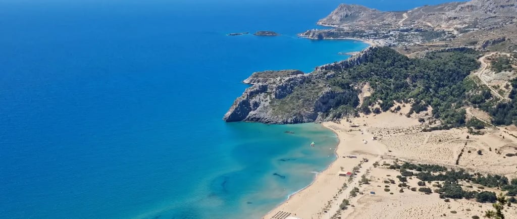 a beach with a sandy beach and a blue sky