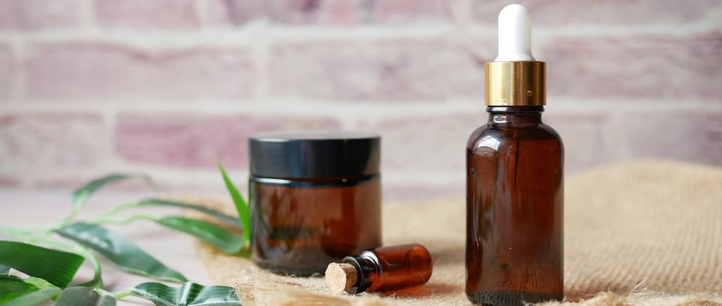 a bottle of essential oils and a jar of essential oils