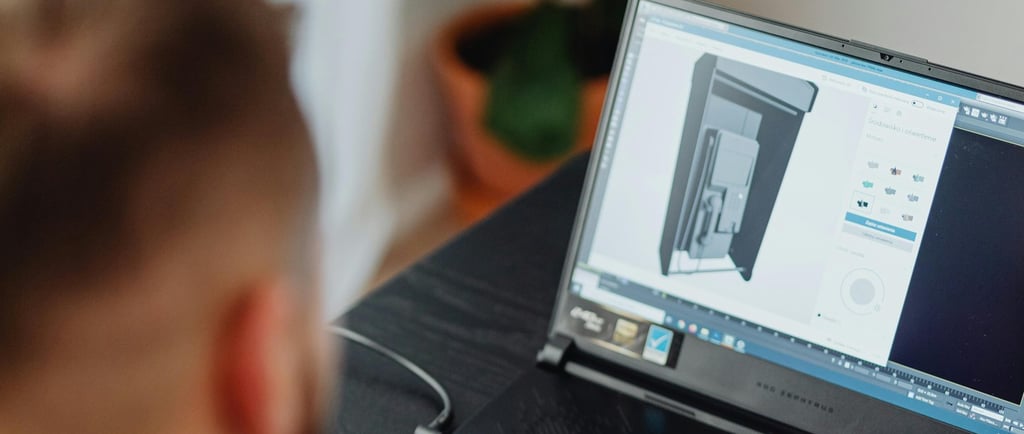 a man sitting at a desk with a laptop computer estimating a custom 3d project