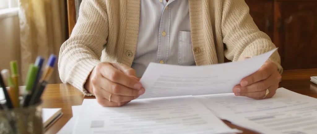 Warm, approachable photo of a senior reviewing documents