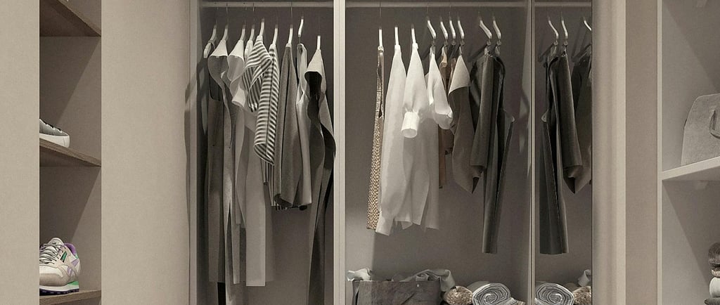 White wardrobe with white / grey tone clothes hanging, shoes, towels and drawersr