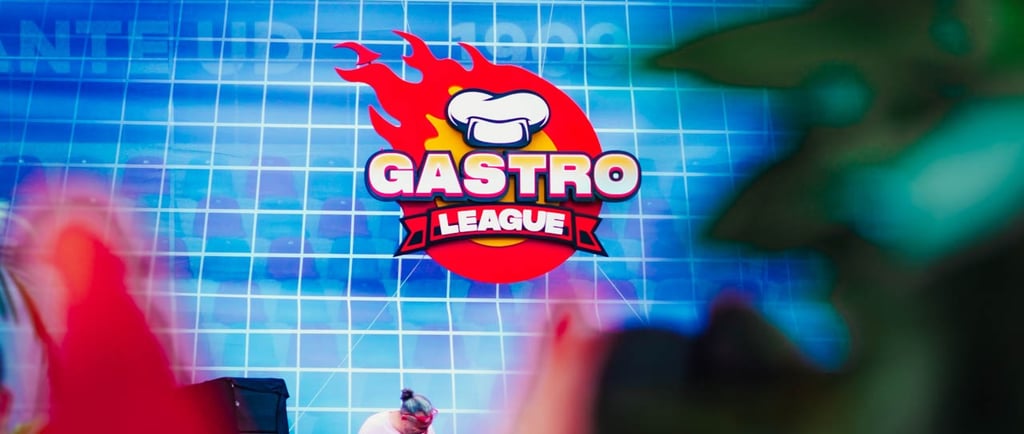 a man in a red suit and red shoes on stage