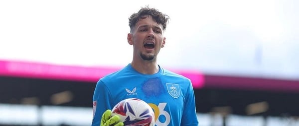 a soccer player is holding a soccer ball