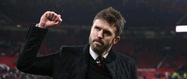 a man in a suit and tie is holding a fist