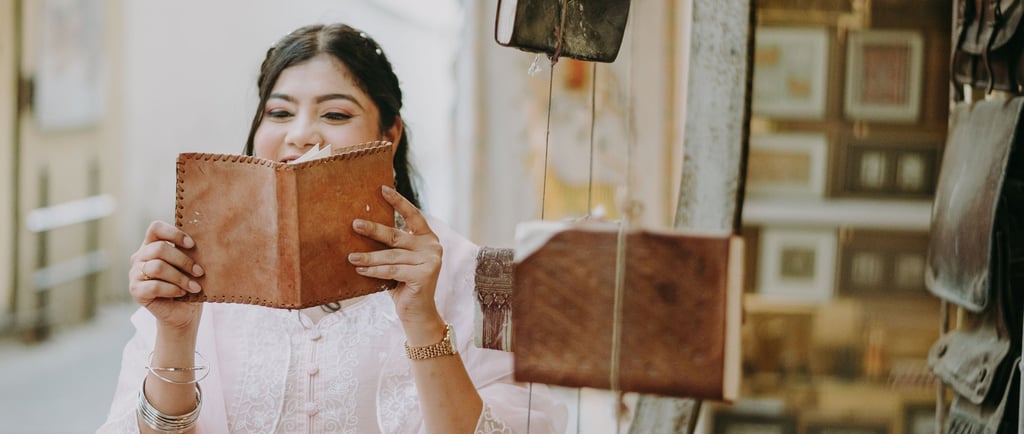a man and woman in the streets of old city, udaipur, reading books