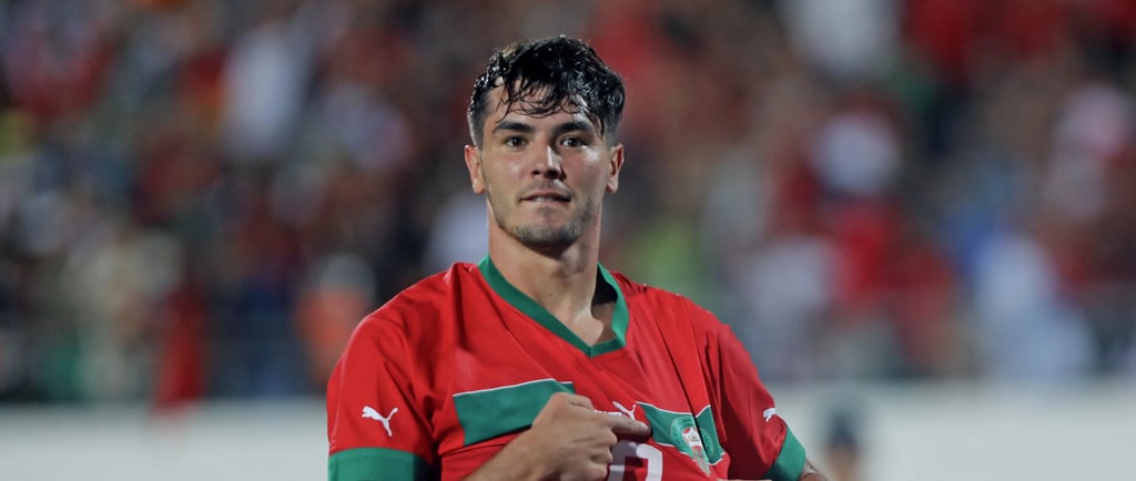 a man in a red shirt is holding a shirt