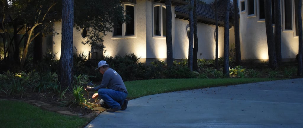 a man kneeling down to a tree in front of a house