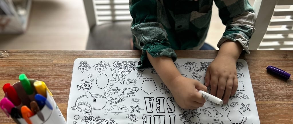 Toddler tracing sea animals on Scribbly Kids Under the Sea reusable drawing mat