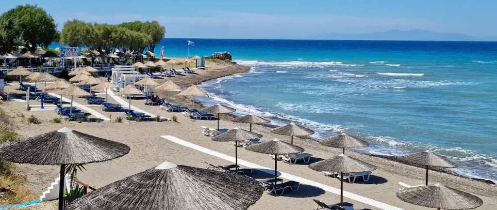 a beach with umbrellas and umbrellas on the beach