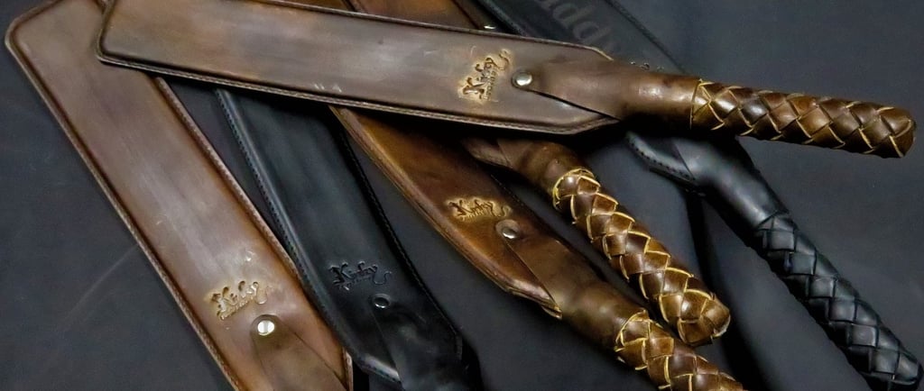 a set of leather paddles with braided handles