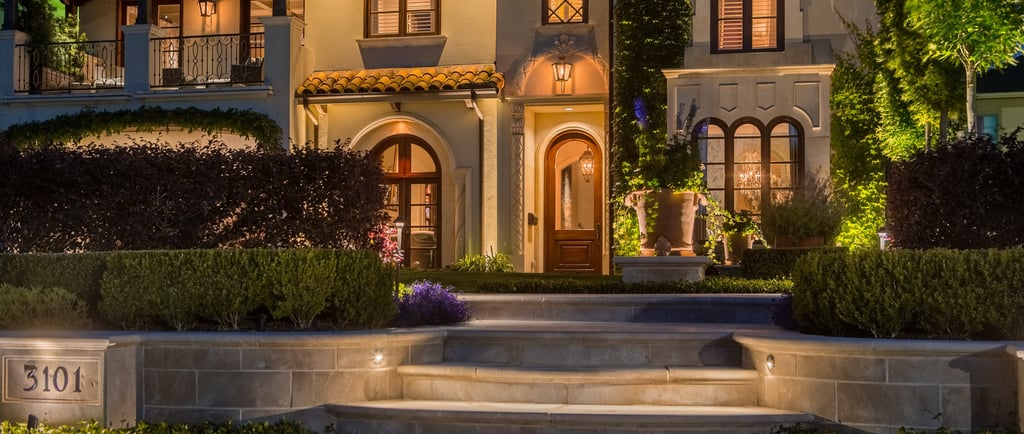 a house with a large front yard and steps leading up to the house