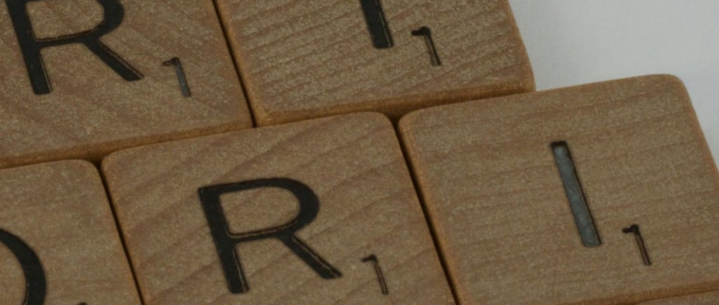 a pyramid shaped wooden block with the word prioritise