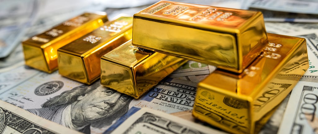high quality gold bullion bars on top of US money