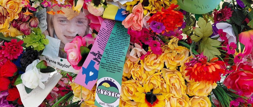 Memorial flowers with young girl's picture among the flood victims