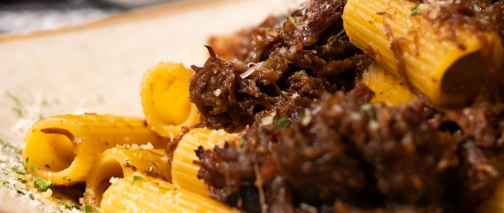 a plate of pasta with pasta and meat