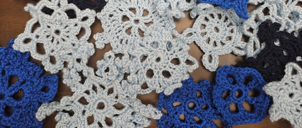 crochet snowflakes on a wooden table