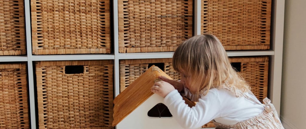 Little girl with play house in front of IKEA Kallax unit with wicker baskets