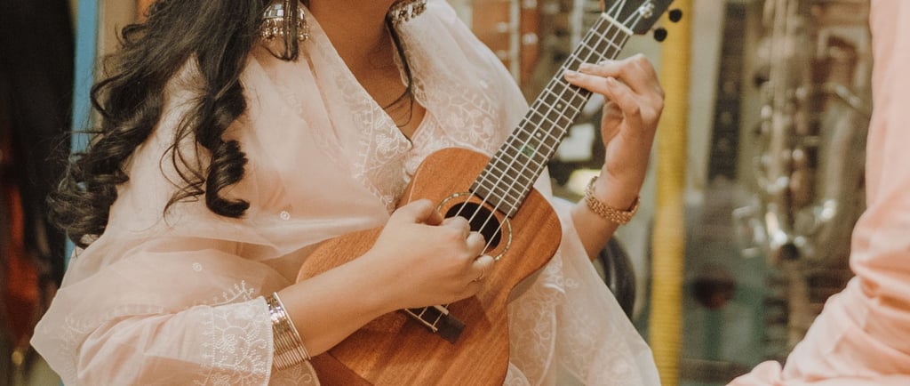 a man and woman playing guitar together