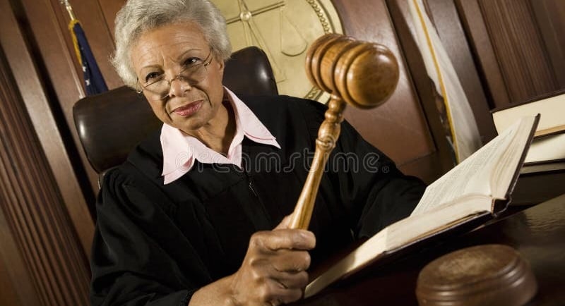 Family court judge strikes the gavel before making a decision in a child support case.